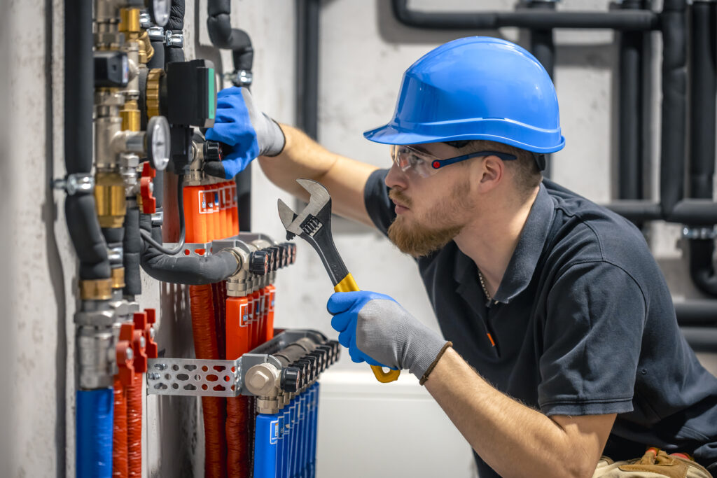 technician checking heating system boiler room scaled